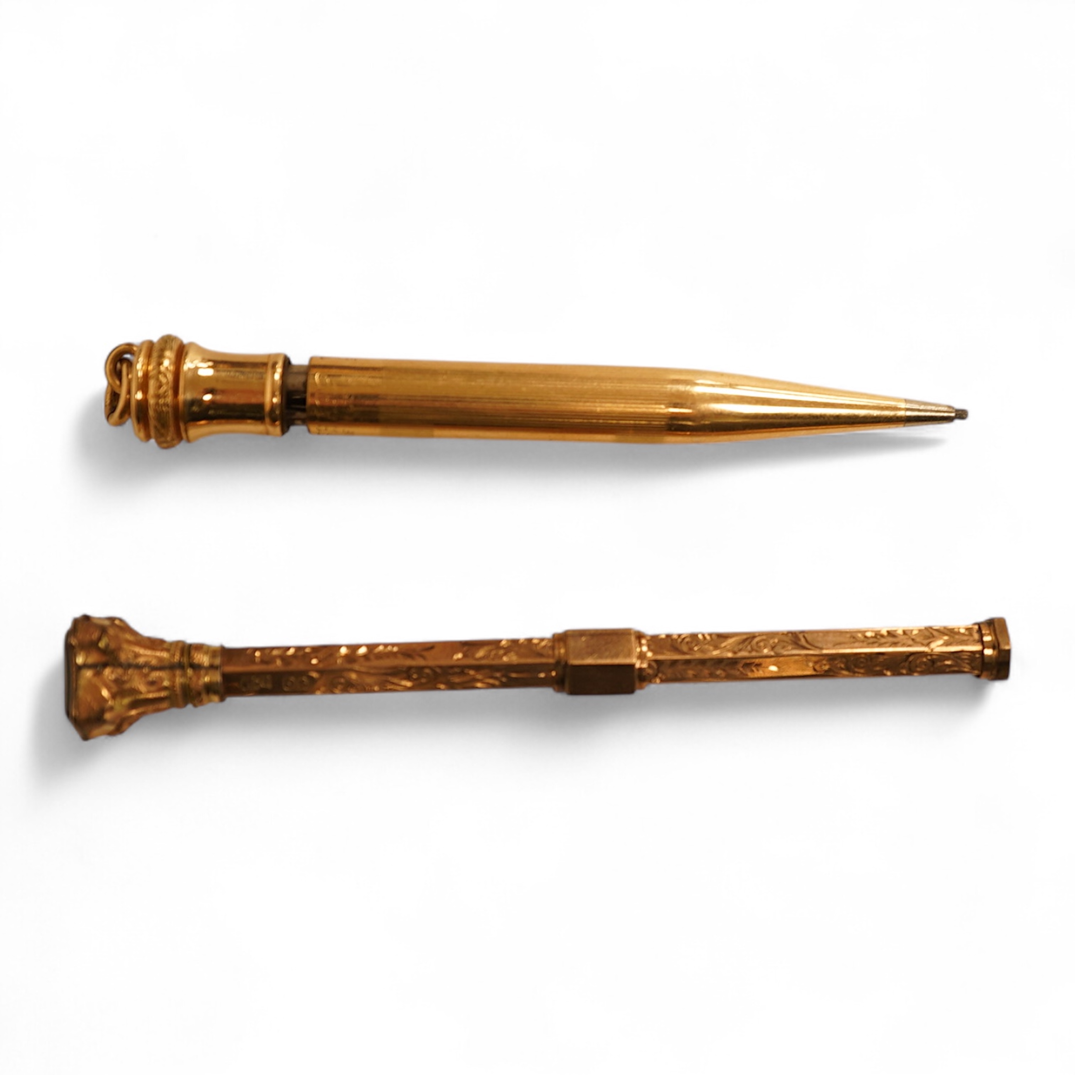 A 9ct gold propelling pencil with engine turned decoration and inset bloodstone terminal and a plain gold filled propelling pencil, largest 11.5cm in length